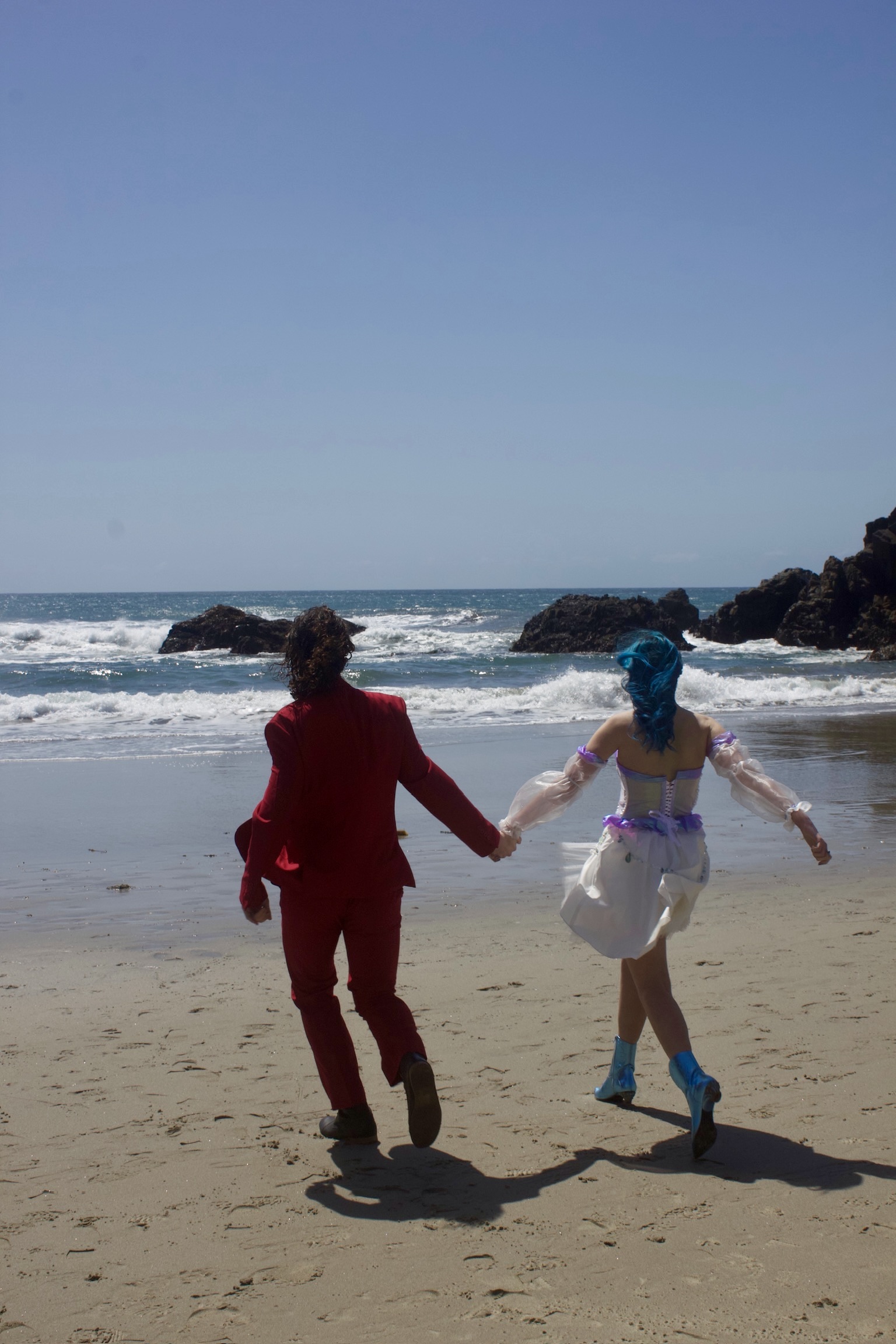 Syd and Noah running on the beach
